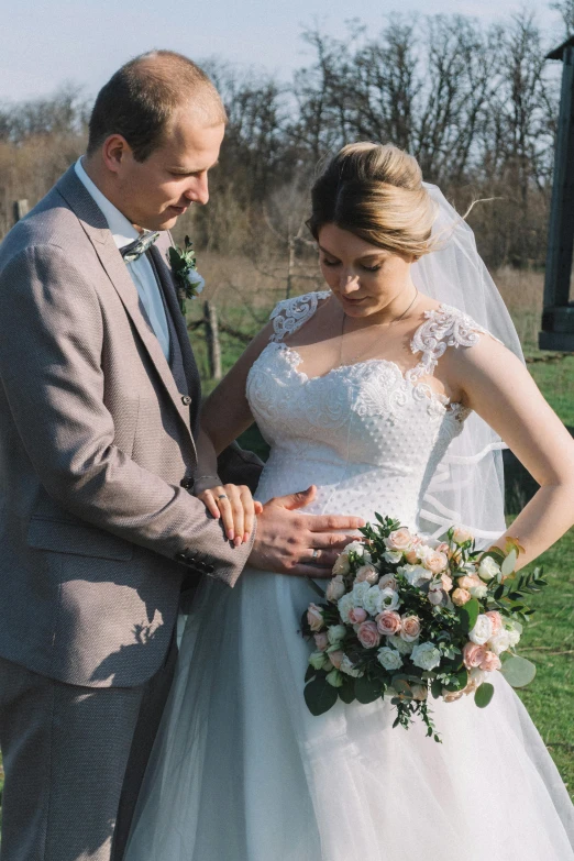 a man and woman in wedding clothes with bouquets