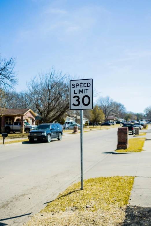 speed limit sign at the corner of an empty road