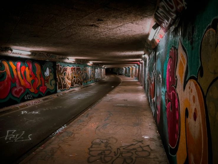an empty subway with graffiti on the walls
