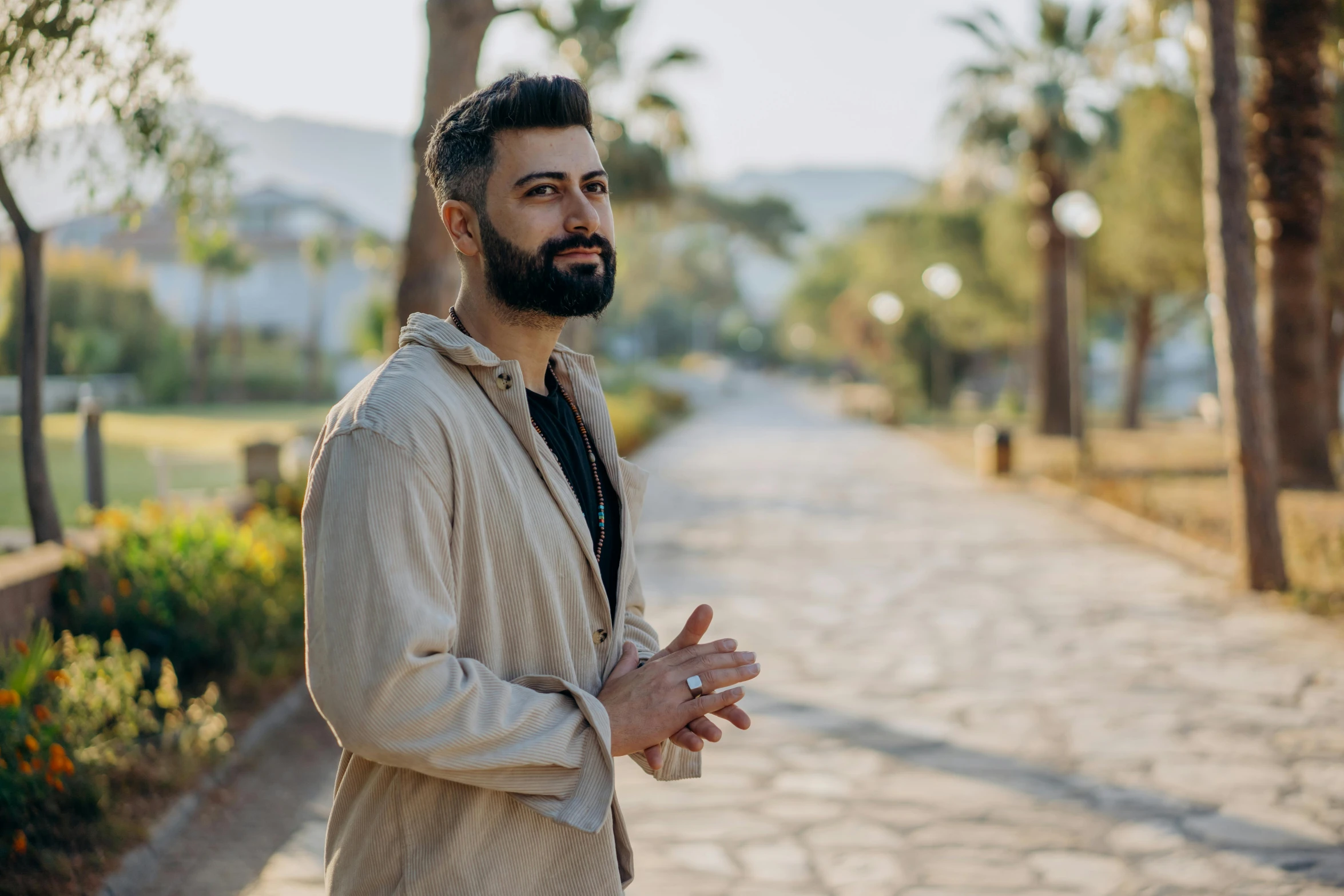 man with beard and ring talking on sidewalk