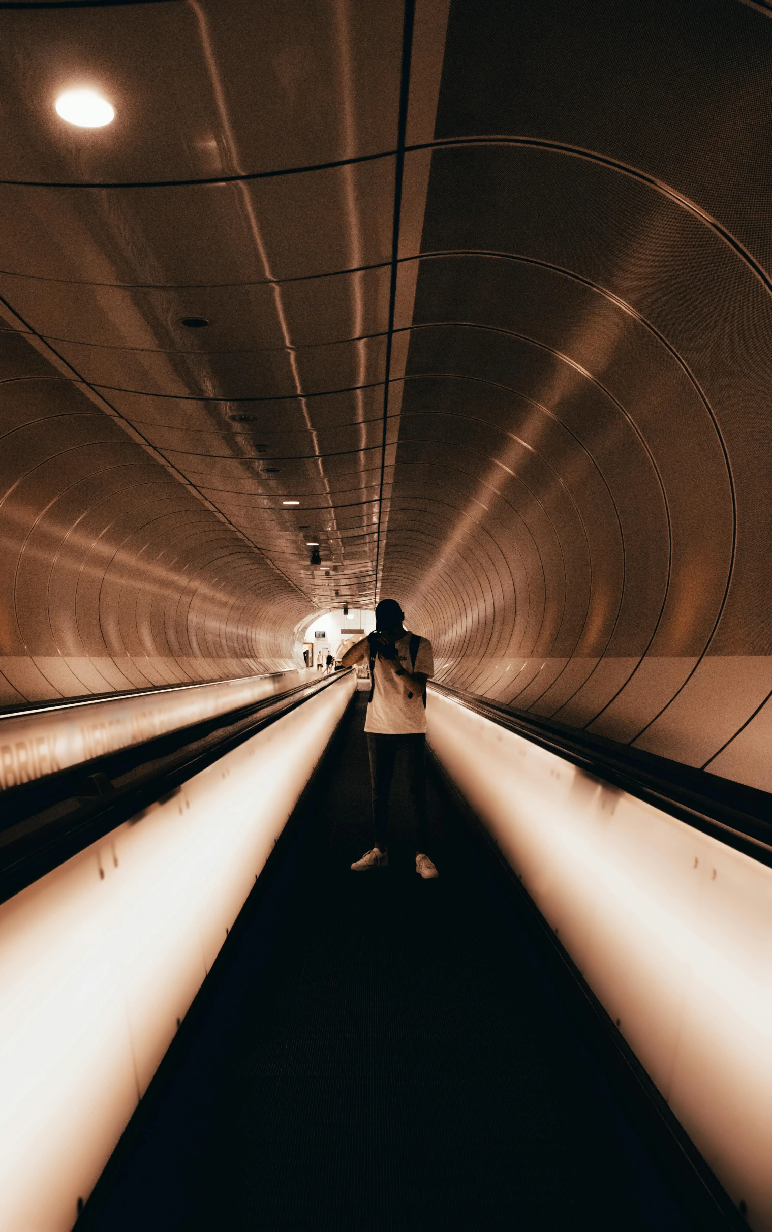 a subway station that is dimly lit with lighting