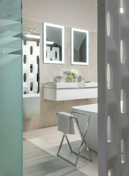 a modern looking bathroom with dual sink vanity and large mirrors