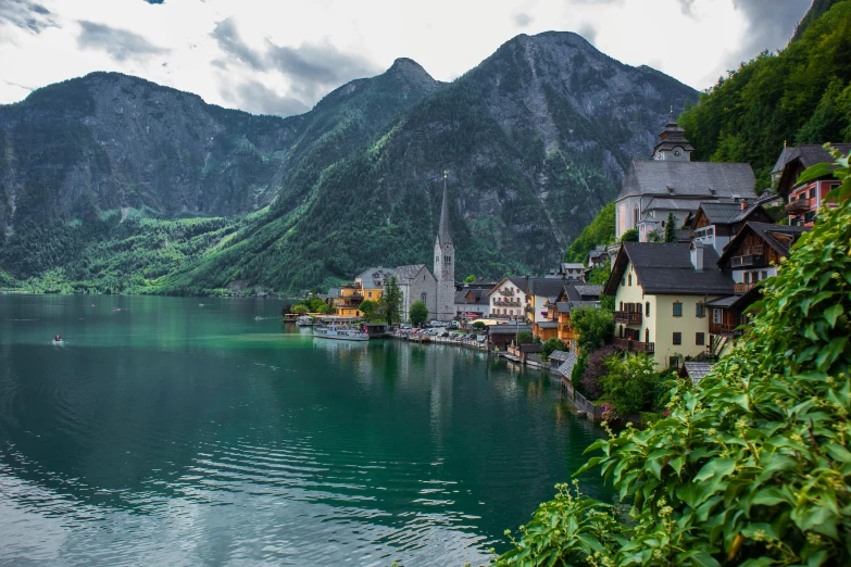 beautiful mountains surrounding lake with houses in it