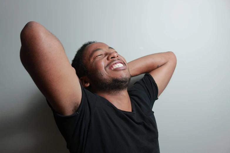 a man poses for a picture while laughing