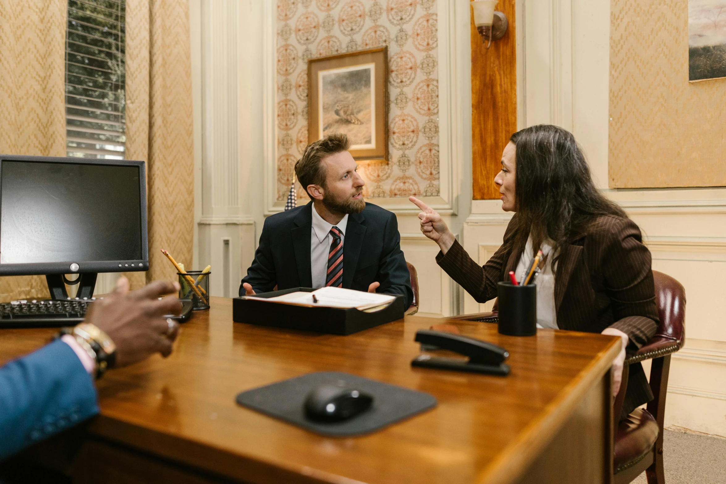 people are talking at the office desk