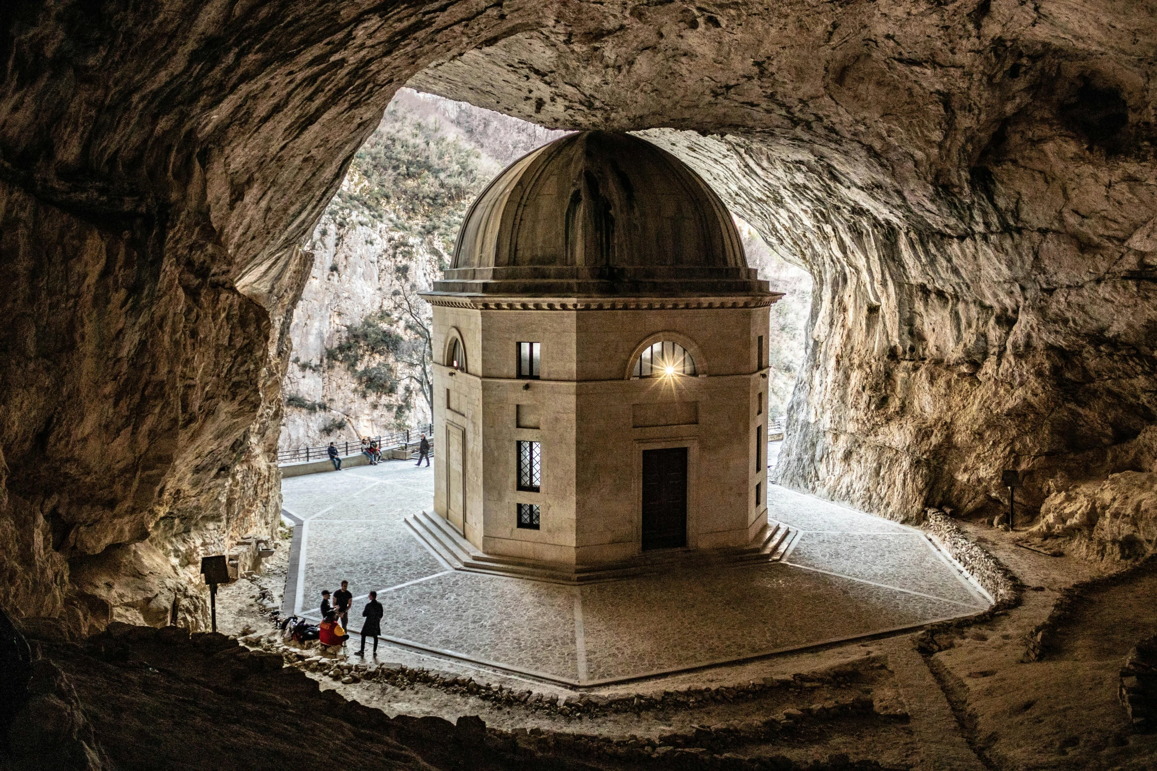 two people stand under a tunnel with a dome