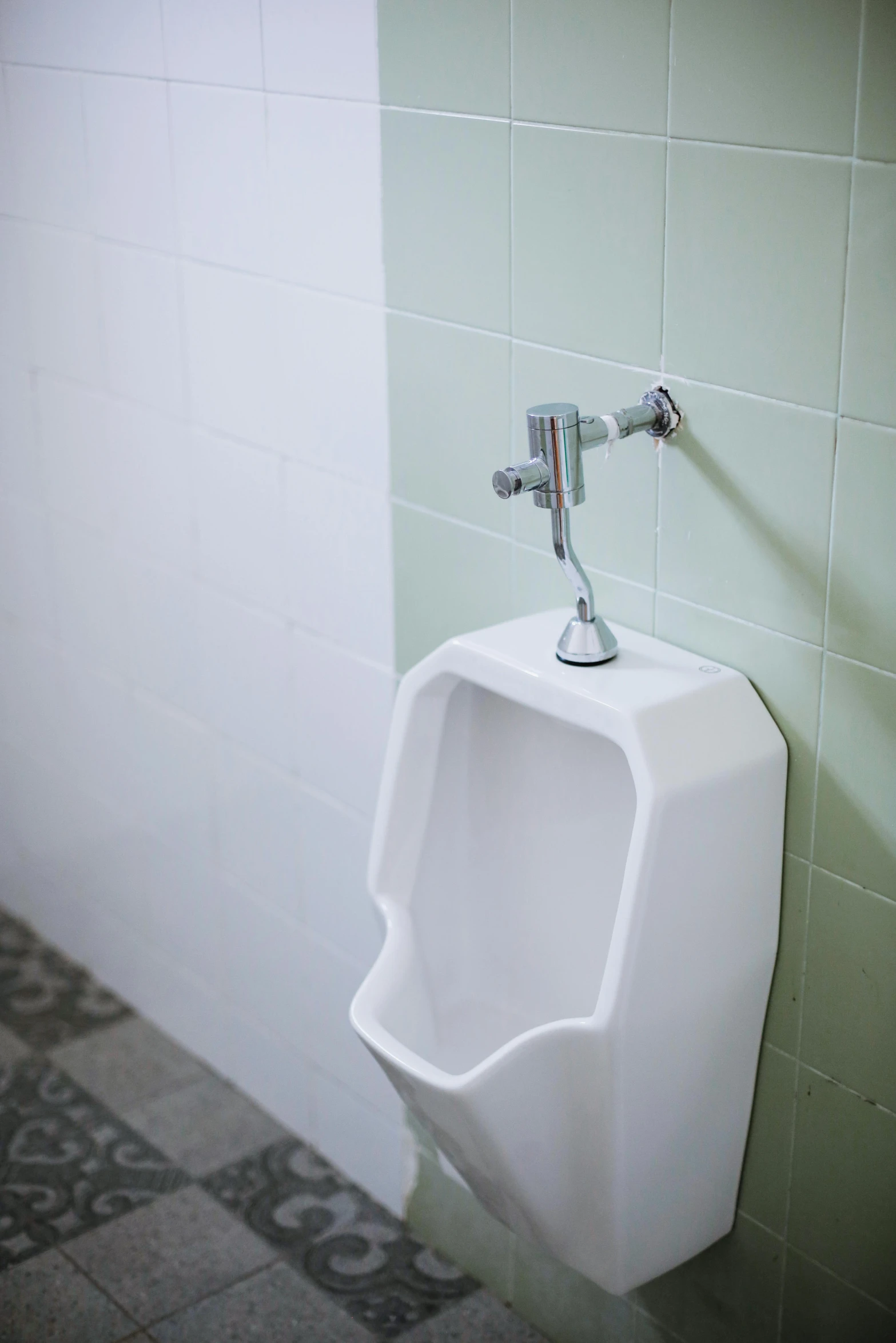 a bathroom urinal hanging on the wall