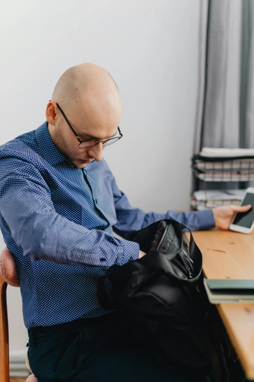 a man sitting down looking at some sort of item