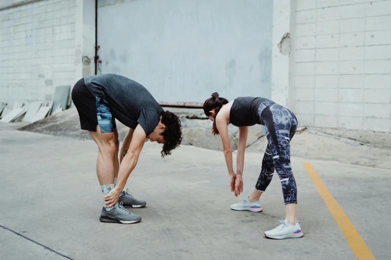 two people standing together looking down at soing