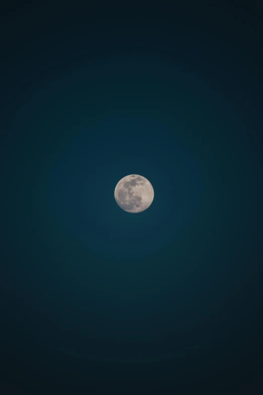 a view of the moon with a single white ball hanging from the center