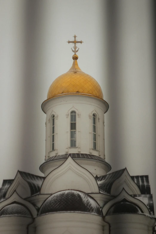 the gold domes on top of a church are visible