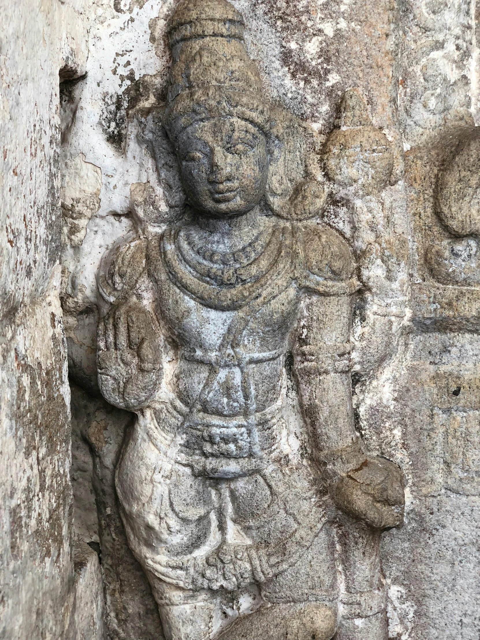 a statue of buddha on a wall in a temple