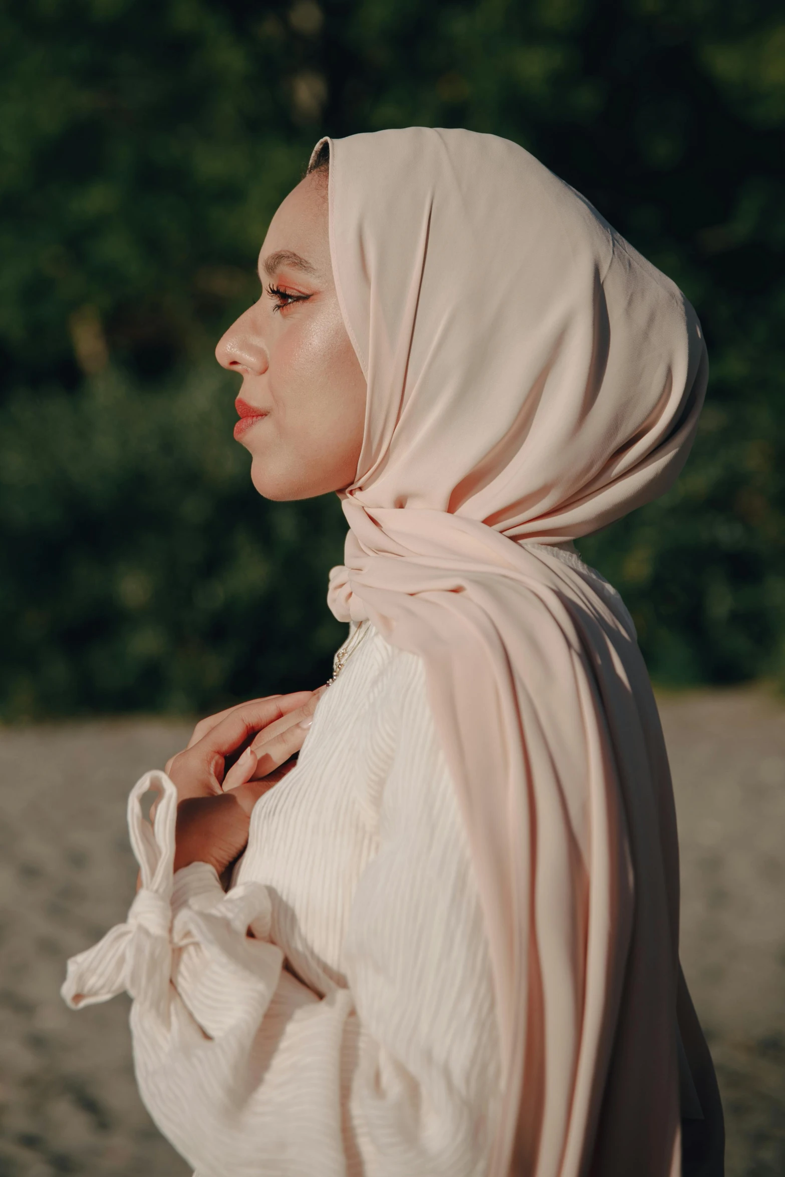 a woman is wearing a veil and standing on the beach