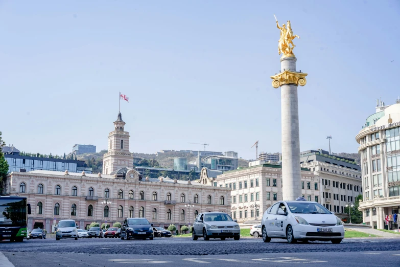 traffic is backed up on the road in front of an ornate building