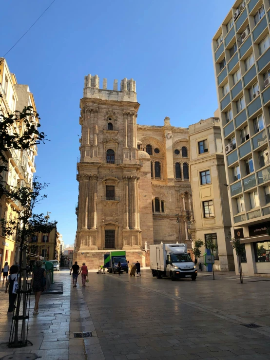 a large brick building sitting next to tall buildings