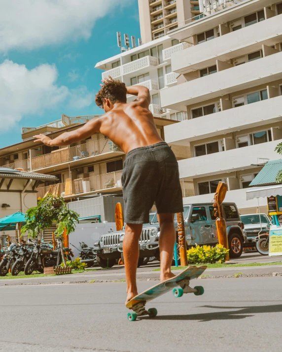 a man riding a skateboard next to a tall building