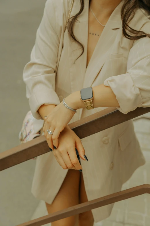 the woman in white blazer is posing on a balcony