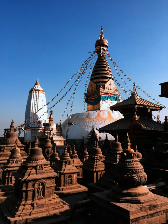 an elaborate structure with many spires in front of a clear blue sky