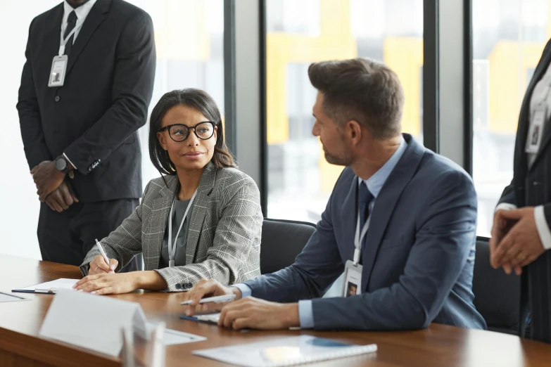 three business people at an office meeting in a conference room