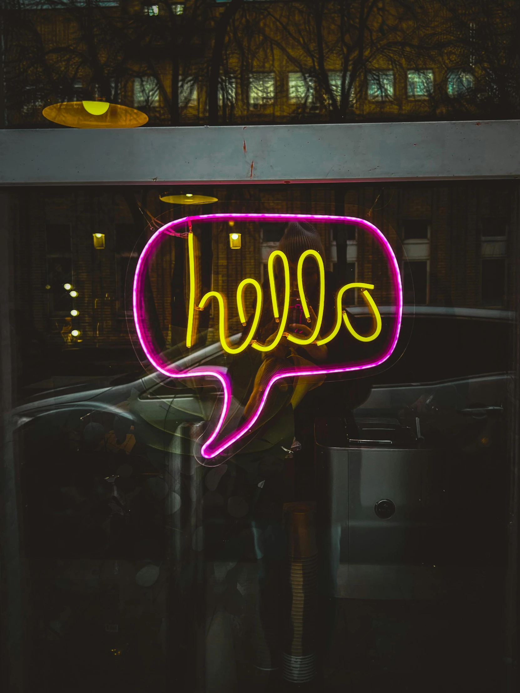 a neon sign is displayed on the side of a building