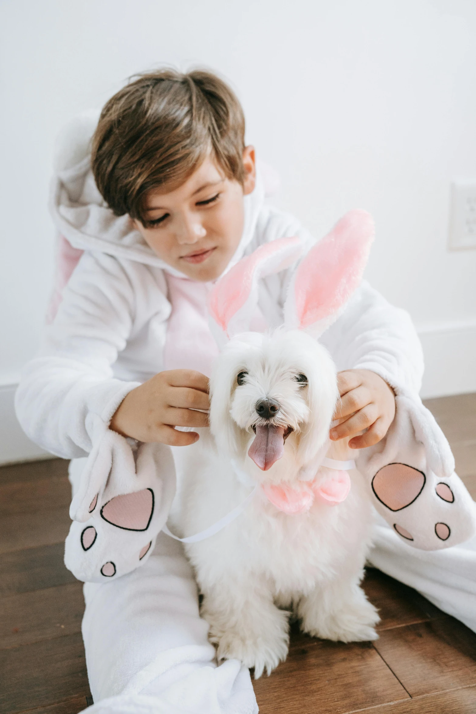 the dog is getting its ears brushed by a little girl