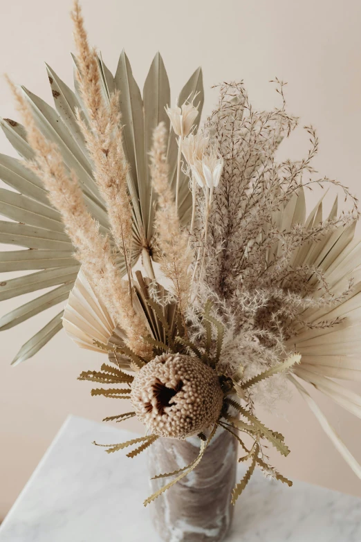 a tall arrangement of wildflowers in a vase