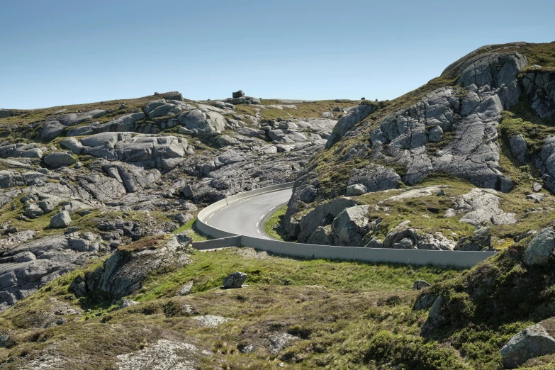 a truck is traveling down a curvy road in the mountains