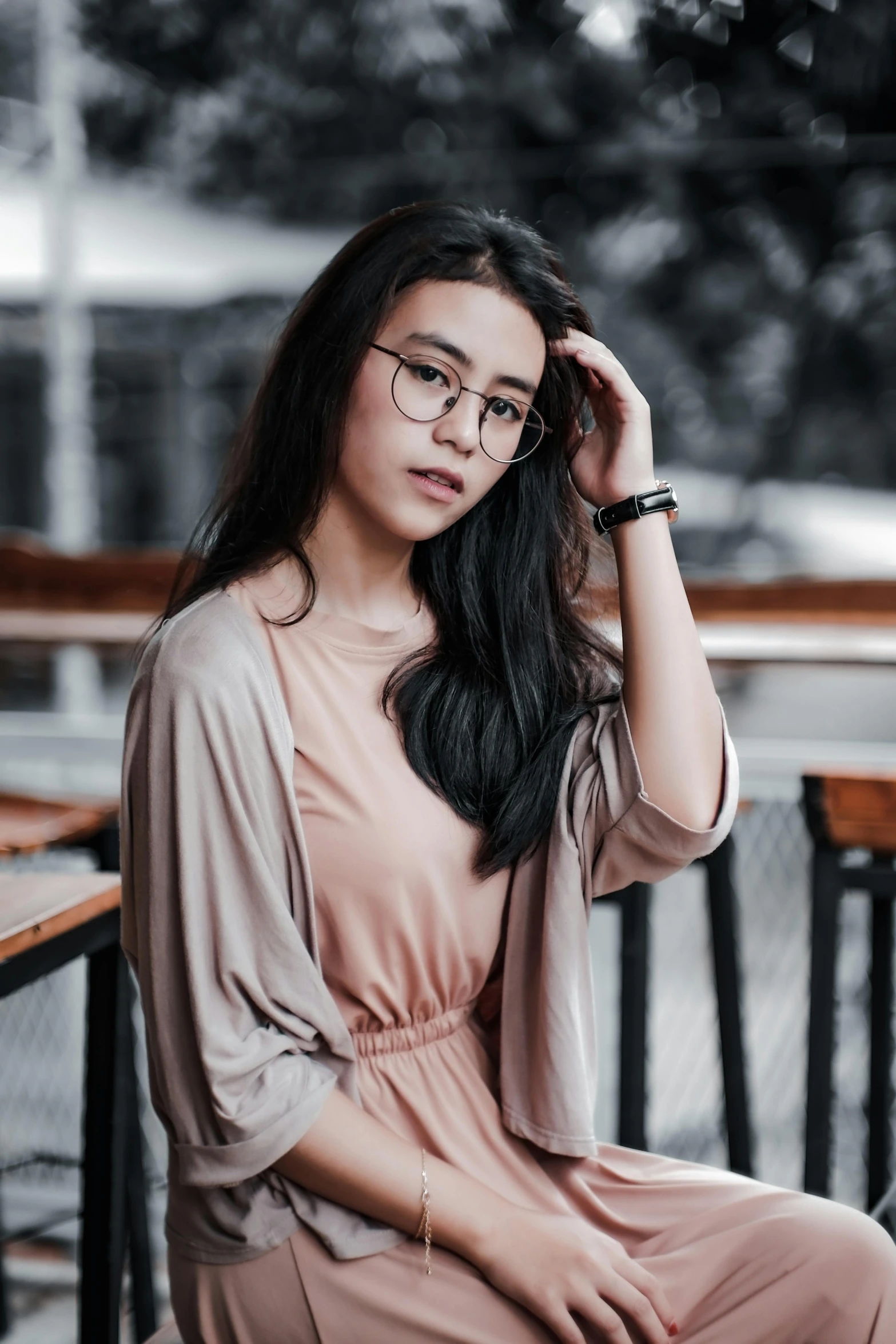 a woman sitting down posing for the camera