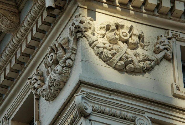 a closeup of the intricately carved architectural detail on the side of an old brick building