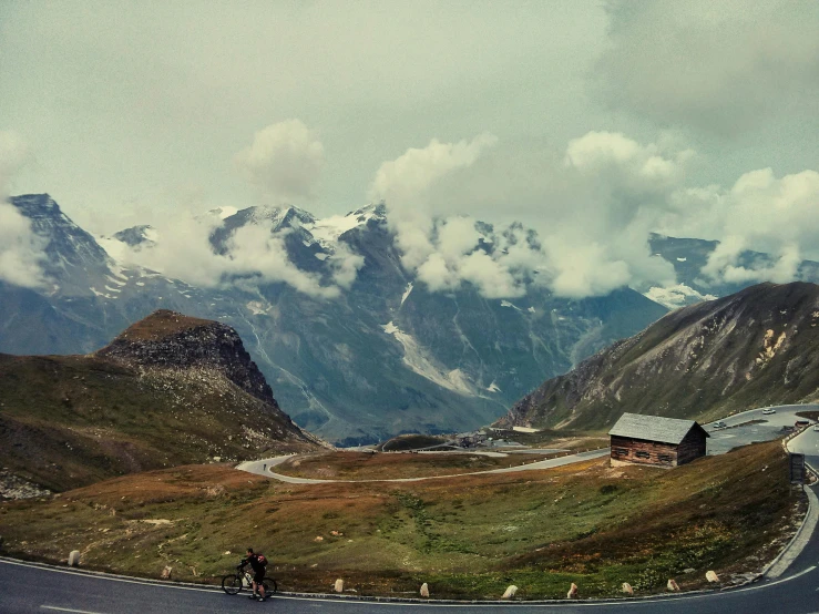 two people riding on bikes on a mountain highway