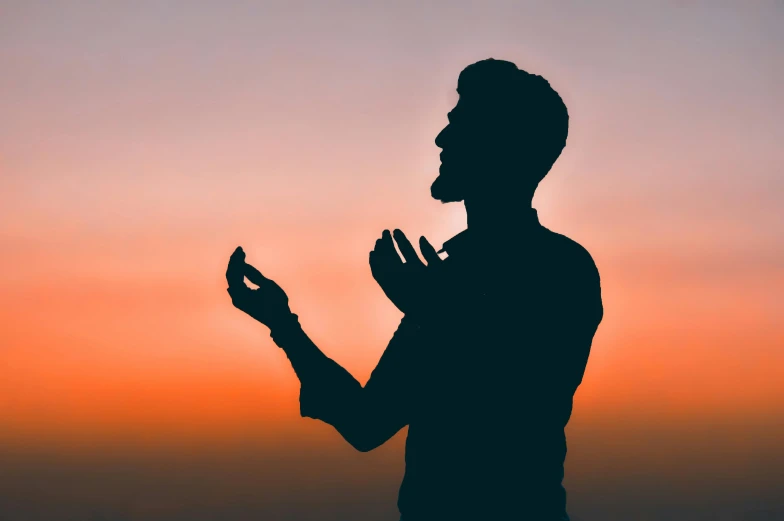 a man is doing an oath at sunrise