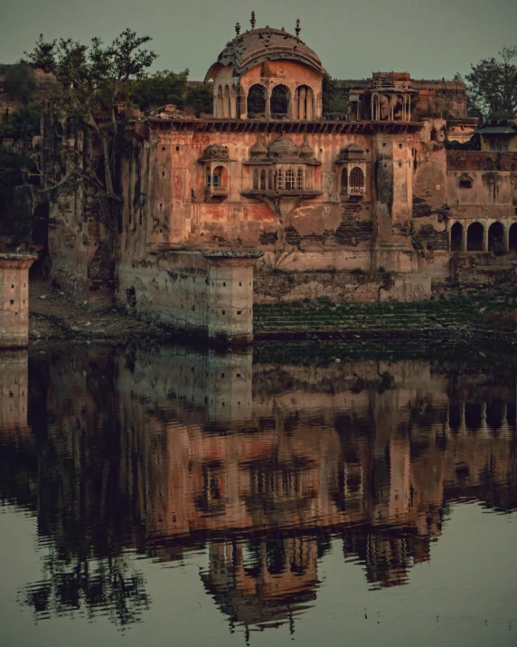 a river with some water and buildings in the background