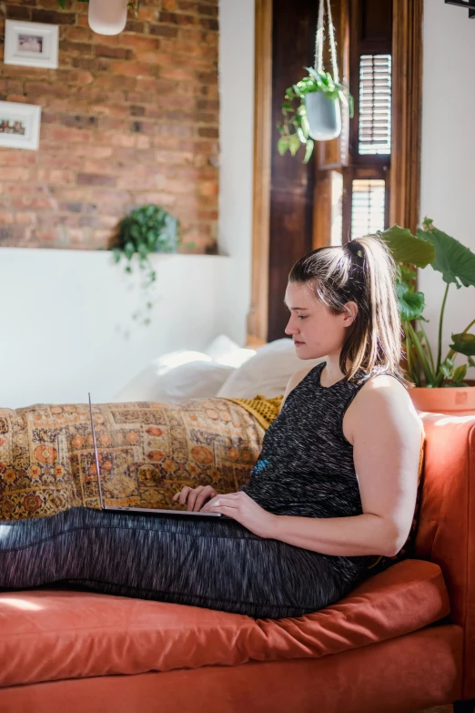 the young woman is sitting on a couch