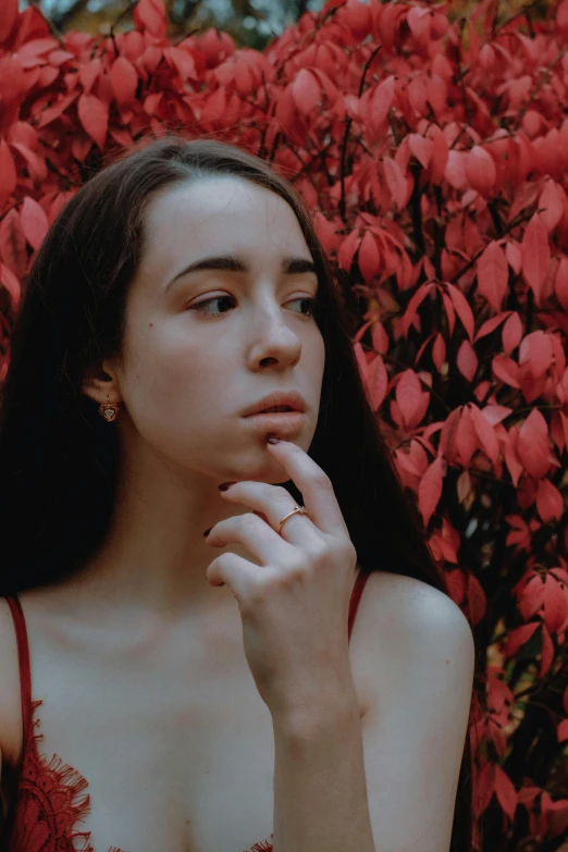 a woman with long black hair and wearing red clothing