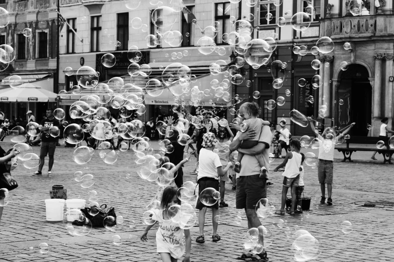 black and white po of people playing bubbles