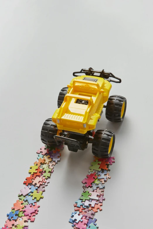 a toy truck is on some pieces of puzzle