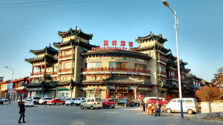 a street scene with an oriental building in the middle of it