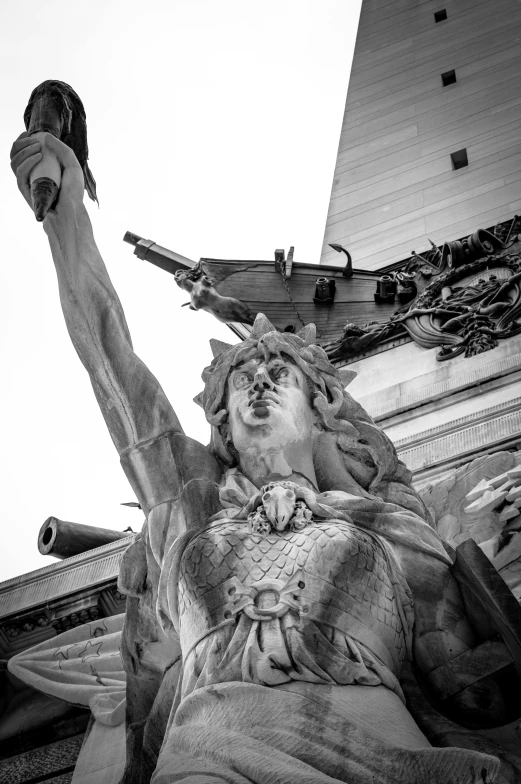 a statue of a man holding a gun with his arm in the air