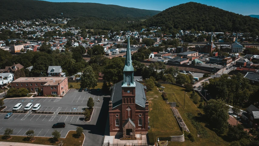 the tower of a church is on top of a hill