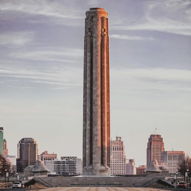 a tall stone pillar in the middle of the city