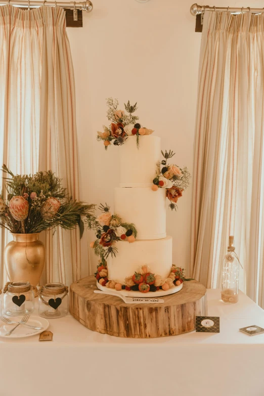 there is a cake and flowers on the table