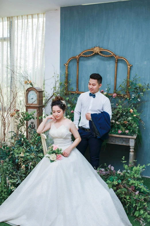 bride sitting on a bench in a blue walled room