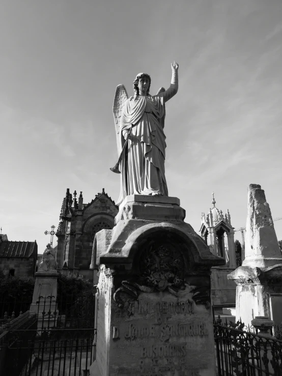 a statue of an angel in a cemetery