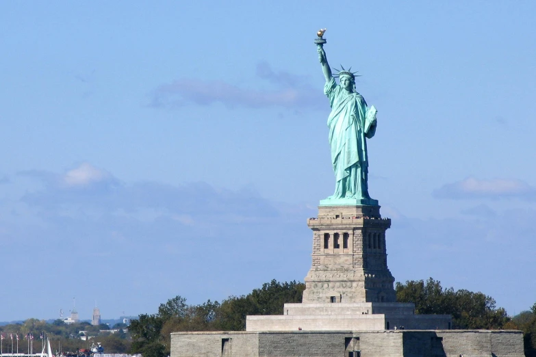 the statue of liberty is against the blue sky