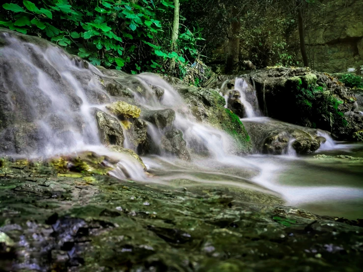 some very pretty rocks and water in a jungle