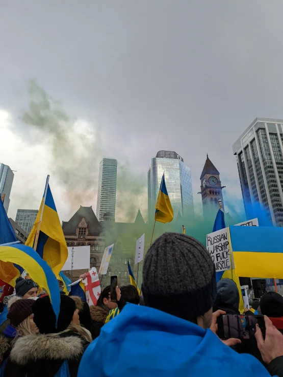 people are standing in a crowd with their flags