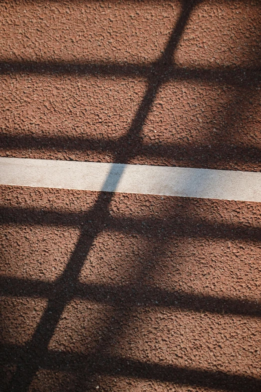 shadows and lines from a shadow of a baseball catcher's mound