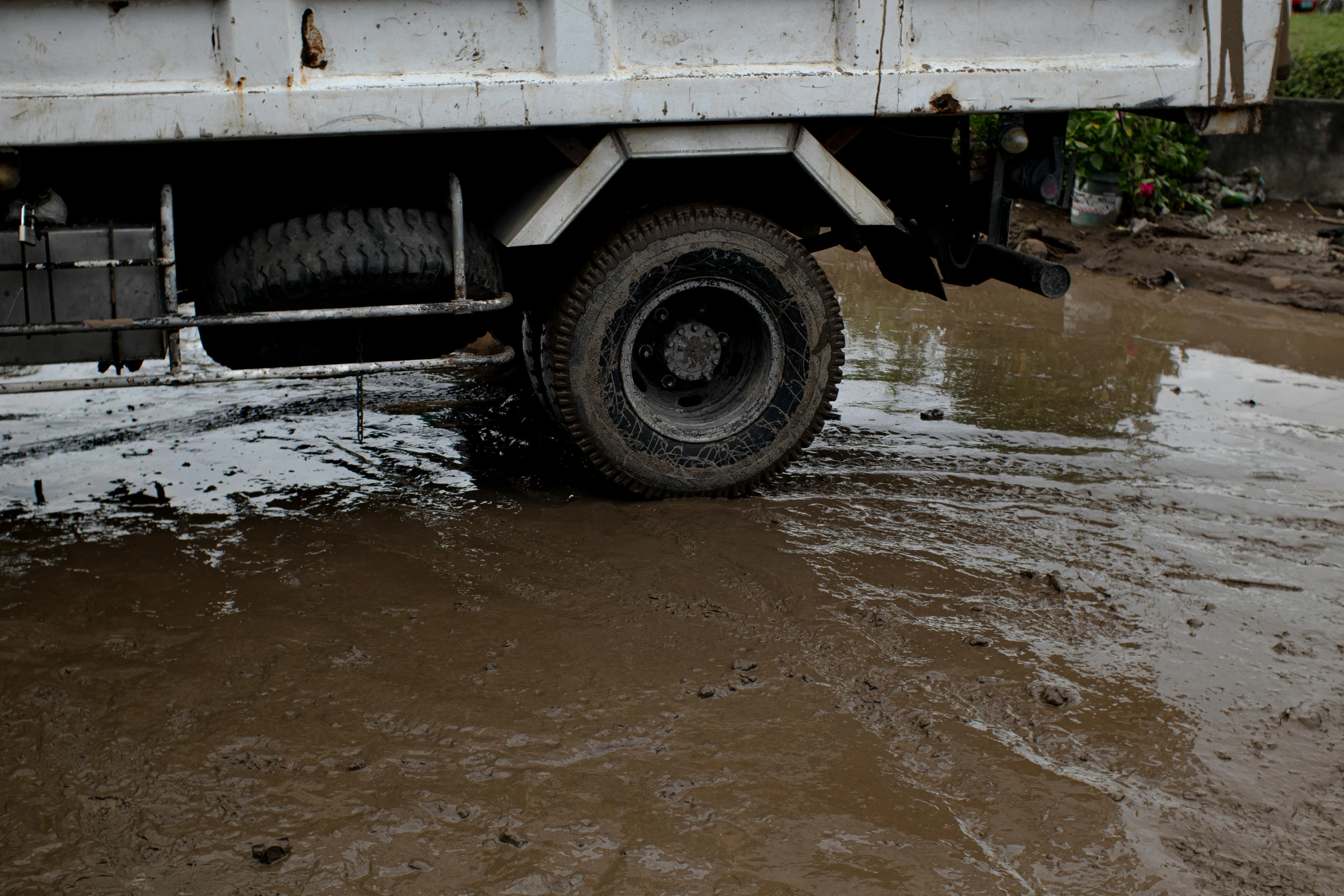 the back of a truck is in deep mud