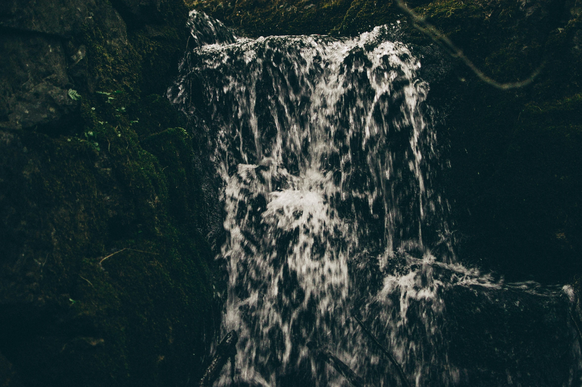 a waterfall cascading from behind and close to the edge