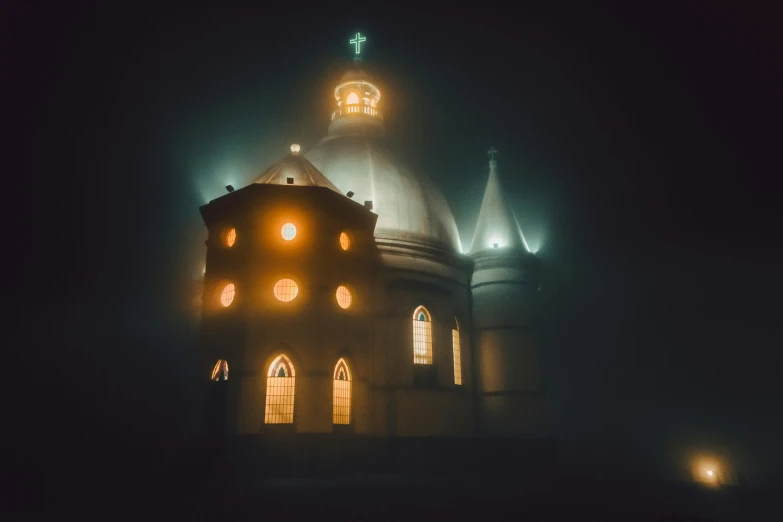 a tower with two clocks on it in the fog